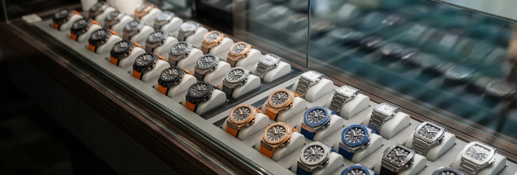 Luxe horloge etalage met meerdere hoogwaardige polshorloges gerangschikt in een glazen vitrine in een boetiekwinkel